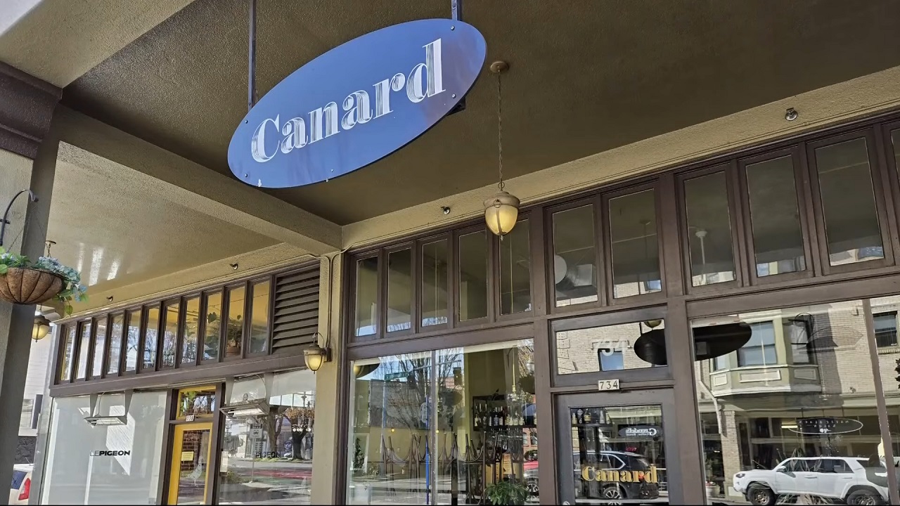 The elegant storefront of Canard, promising a fusion of casual and fine dining in a chic environment